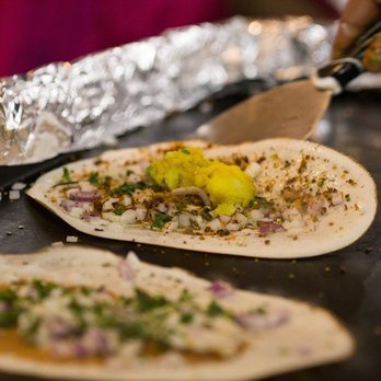 Godavari Columbus - a person cutting a tortilla - Indian Near Me - Columbus, Ohio