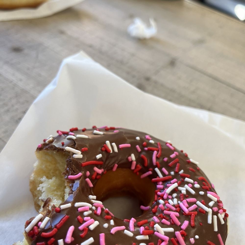 a chocolate frosted donut with sprinkles
