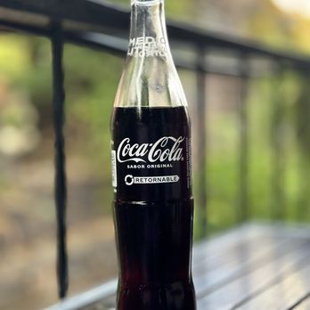 El Arroyo - a bottle of coca cola on a wooden table - Mexican Near Me - Sonora, California El Arroyo - a bottle of coca cola on a wooden table - Mexican Near Me - Sonora, California