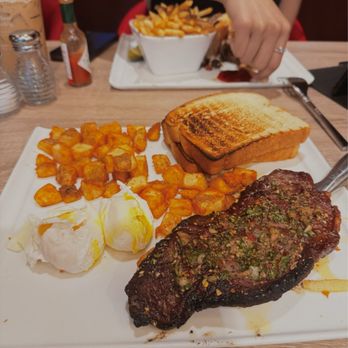 Delights - Steak and eggs with cut potatoes and a side of toasted white bread - Delis Near Me - Las Vegas, Nevada Delights - Steak and eggs with cut potatoes and a side of toasted white bread - Delis Near Me - Las Vegas, Nevada