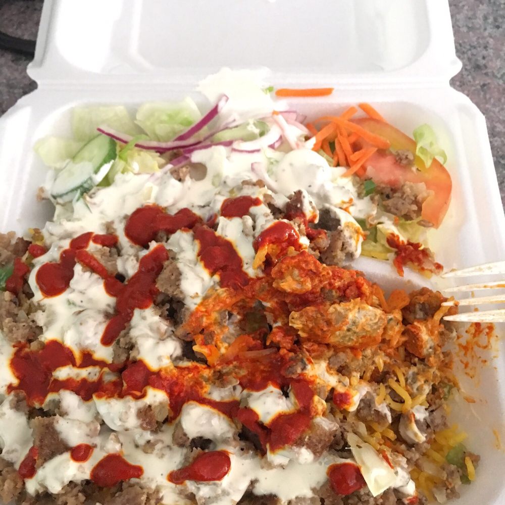 Yassa Grill - Lamb over rice with extra red sauce for some heat - Food Trucks Near Me - Lowell, Massachusetts Yassa Grill - Lamb over rice with extra red sauce for some heat - Food Trucks Near Me - Lowell, Massachusetts