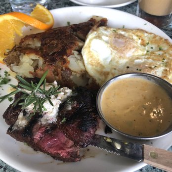 Plums Cafe - Flat iron steak and eggs. Eggs over medium and steak medium rare. I ask for a side of chipotle cilantro hollandaise to dip my steak in. - Breakfast & Brunch Near Me - Costa Mesa, California
