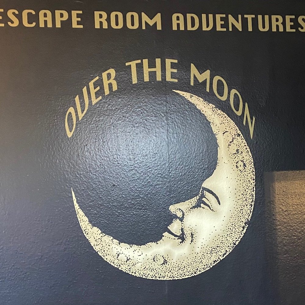 Over The Moon Escape Rooms - Logo on the wall in the lobby - Escape Games Near Me - Corona, California Over The Moon Escape Rooms - Logo on the wall in the lobby - Escape Games Near Me - Corona, California