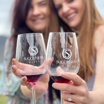 Succession Wines - two women holding wine glasses - Wine Tasting Room Near Me - Manson, Washington Succession Wines - two women holding wine glasses - Wine Tasting Room Near Me - Manson, Washington