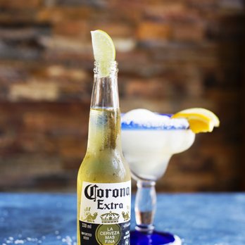 Lone Star Texas Grill - a bottle of corona extra with a margarita in the background - Tex-Mex Near Me - Belleville, Ontario Lone Star Texas Grill - a bottle of corona extra with a margarita in the background - Tex-Mex Near Me - Belleville, Ontario