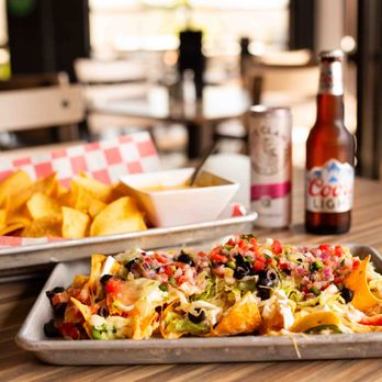 Big E's Sports Grill - 1/2 nacho and 1/2 queso+chips from our $6 happy hour menu - Sports Bars Near Me - Midland, Michigan Big E's Sports Grill - 1/2 nacho and 1/2 queso+chips from our $6 happy hour menu - Sports Bars Near Me - Midland, Michigan