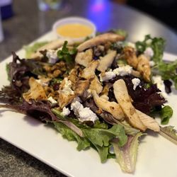 Tavern on First - Tavern Salad - spring mix (not just iceberg!!), goat cheese, walnuts, craisins, and chicken with a honey mustard vinaigrette dressing.