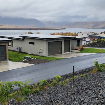 IVE Landscaping - a view of a house with a lake in the background - Landscaping Near Me