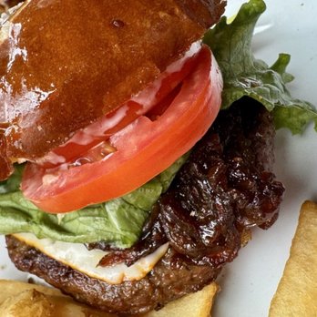 Pumphouse Brewery - More of the delicious Muenster Burger with that butter topped pretzel bun and crunchy salt. SO good! - Breweries Near Me - Longmont, Colorado