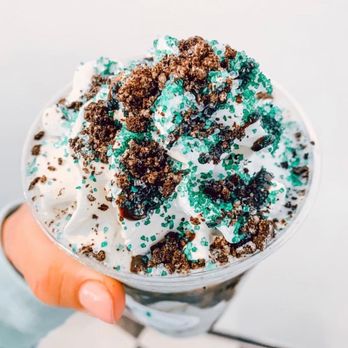 Tanked Up Nutrition - a hand holding a cup of ice cream with green sprinkles - Health Markets Near Me - College Station, Texas Tanked Up Nutrition - a hand holding a cup of ice cream with green sprinkles - Health Markets Near Me - College Station, Texas