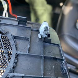 I guess the installer slipped when using the dremel because he hacked up the part that holds the speaker cover in place on the dash