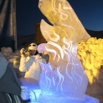 The Ice Bar - a man taking a picture of the ice sculpture - Lounges Near Me - Olympic Valley, California