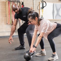 Essers of Los Angeles - Coach Jimmy working with one of our athletes on Kettlebell Swings