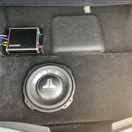 Custom fiberglass 10" flat JL subwoofer in spare tire wheel area