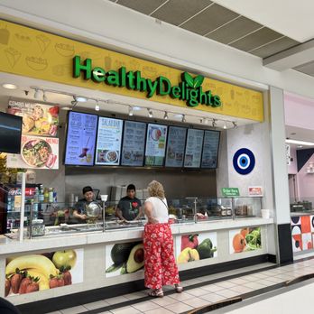 Healthy Delights - a woman standing in front of a counter - Desserts Near Me - Miami, Florida Healthy Delights - a woman standing in front of a counter - Desserts Near Me - Miami, Florida