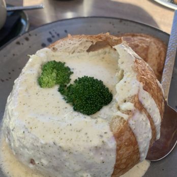 Reunion Kitchen + Drink - Creamy broccoli soup served in a bread bowl. - New American Near Me - Corona, California Reunion Kitchen + Drink - Creamy broccoli soup served in a bread bowl. - New American Near Me - Corona, California