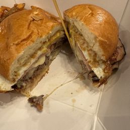 Inside the farm burger! Ham, bacon, fried egg, mixed cheeses, an all American beef patty, mayo and I added a splash of mustard.