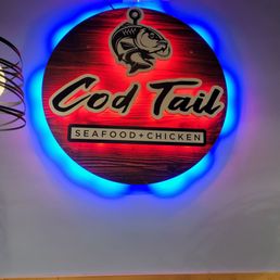 a neon sign for a seafood restaurant