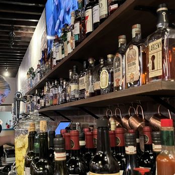 Brickstone Kitchen - a bar counter with bottles of liquor - Pizza Near Me - Sutton, Massachusetts