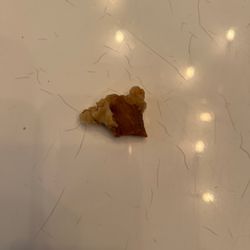 This piece of M2. Sesame Chicken is harder than the table it is sitting on.