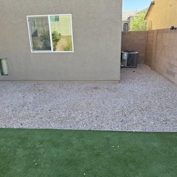 Bud's Affordable Landscaping - Before Backyard right side in need of paver wall between rocks and turf - Landscaping Near Me