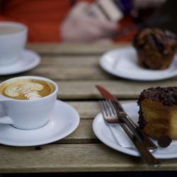 Qūentin - Cappuccino and a cream-filled, chocolate-covered pastry