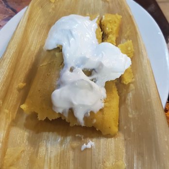 RJM Rancho BBQ - a plate of tamales with sour cream - Salvadoran Near Me - Passaic, New Jersey