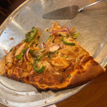 Desi Aroma - a slice of pizza on a pan - Indian Near Me - Rancho Cucamonga, California
