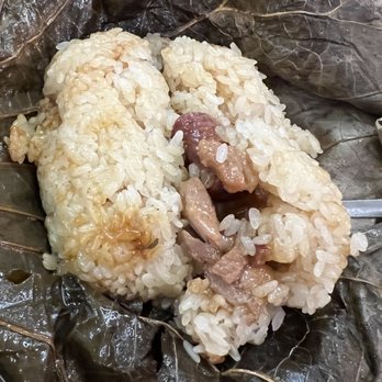 Tim Ho Wan - Sticky rice in lotus leaf (chicken, shiitake, Chinese sausage) - Dim Sum Near Me - Katy, Texas Tim Ho Wan - Sticky rice in lotus leaf (chicken, shiitake, Chinese sausage) - Dim Sum Near Me - Katy, Texas