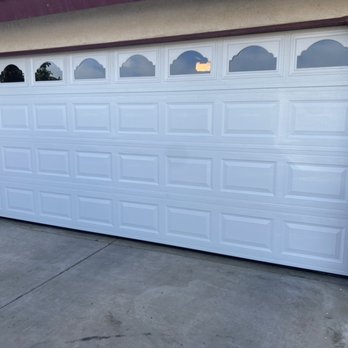Reyes Garage Doors - White garage door with "cathedral" window design - Garage Door Services Near Me Reyes Garage Doors - White garage door with "cathedral" window design - Garage Door Services Near Me
