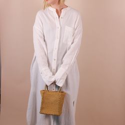 Kinkan Gifts - A white maxi dress for women with a tan woven seagrass bag