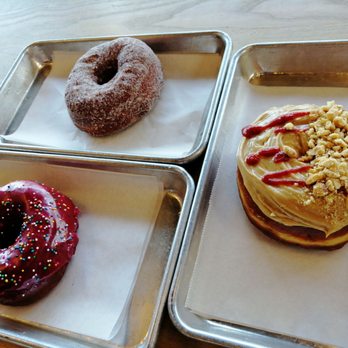 Good Dough - Left to right: The "Molly Ringwald", Cardamom Sugar Raised, Peanut Butter & Sriracha - Donuts Near Me - Jacksonville, Florida Good Dough - Left to right: The "Molly Ringwald", Cardamom Sugar Raised, Peanut Butter & Sriracha - Donuts Near Me - Jacksonville, Florida