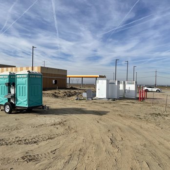 Tesla Supercharger - Bakersfield - Port-a-John's in back of chargers. - EV Charging Stations Near Me - Bakersfield, California