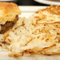 The Carriage House Restaurant - Chicken fried steak on a biscuit with gravy and hash browns