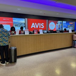 Avis Car Rental - You can see a worker wearing a red Avis shirt, but she was working the shorter, Budget line