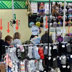 Dollar Tree - Zoom in and you can count the five people waiting for service while 3 workers are chatting 15ft away