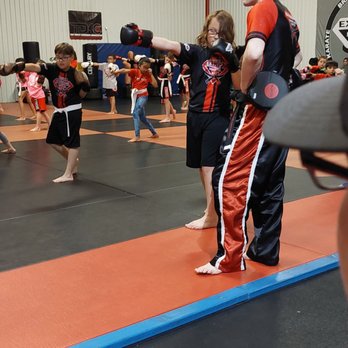 Extreme Martial Arts - Coaches take turns giving each kid a little 1-on-1 time - Martial Arts Near Me - Amarillo, Texas