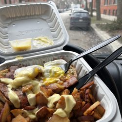 Janik's Cafe - Egg Benedict with ham and we'll seasoned potatos over a creamy house sauce