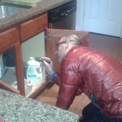 Fabian's Upstate Home Inspection - Inspecting the plumbing under the kitchen sink.
