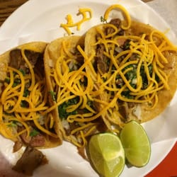 Three lengua tacos with cheese.