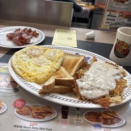 3 eggs over light , bacon , hash browns with onions and covered with gravy. 3 eggs over light , bacon , hash browns with onions and covered with gravy.