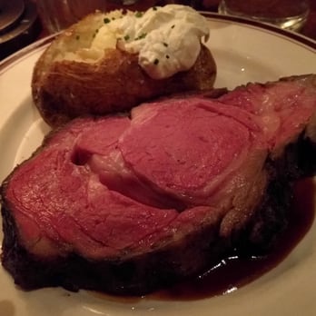 Ozzie's Good Eats - A medium rare hunk of prime rib, with the baked potato. - American Near Me - Fairfax, Virginia Ozzie's Good Eats - A medium rare hunk of prime rib, with the baked potato. - American Near Me - Fairfax, Virginia