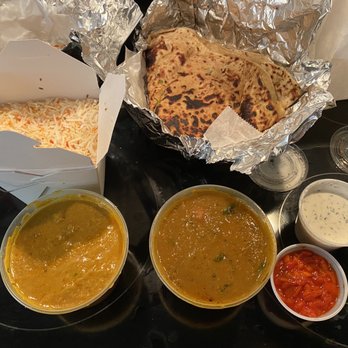 India Quality Restaurant - Goat Coconut with Bone (front left), lamb curry (front right), Aloo Paratha (back right) - Indian Near Me - Boston, Massachusetts India Quality Restaurant - Goat Coconut with Bone (front left), lamb curry (front right), Aloo Paratha (back right) - Indian Near Me - Boston, Massachusetts