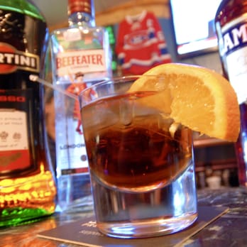 Bruno Sport Bar - a shot of a drink with a slice of lemon - Sports Bars Near Me - Montreal, Quebec