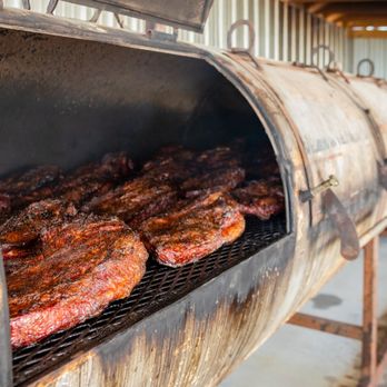 Mike Cotten's BBQ - ribs cooking on a grill - Barbeque Near Me - Corpus Christi, Texas