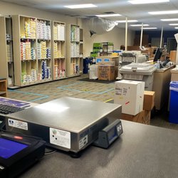 FedEx Office Print & Ship Center - Open copy area behind counter.