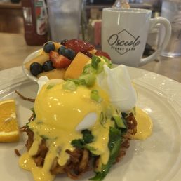 Sunday special menu. Poached eggs Florentine over potato pancake.