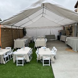 We customized this canopy setup to perfectly fit their backyard space   Tables, resin chairs for both adults + kids provided.