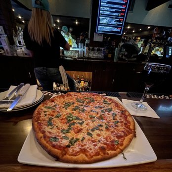 Mike's Pizzeria - a large pizza on a plate - Italian Near Me - Fresno, California Mike's Pizzeria - a large pizza on a plate - Italian Near Me - Fresno, California