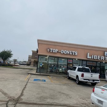 Top Donuts - cars parked in front of the store - Donuts Near Me - Spring, Texas